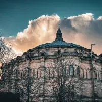 McEwan Hall against a bright cloud and dark sky.